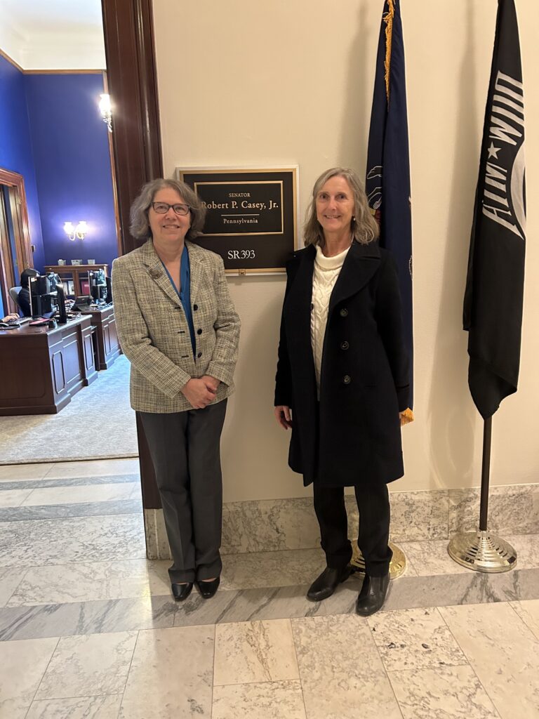 Dr. Carol Beck and Dr. Pamela Hornby stand in front of the office of Senator Robert P. Casey, Jr.