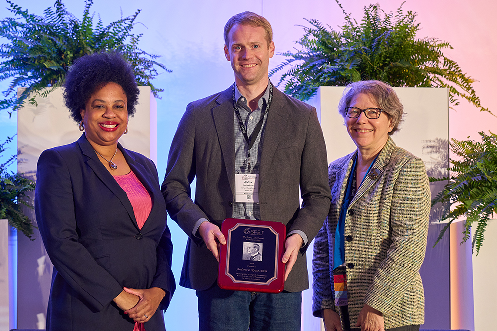 An ASPET 2024 attendee receiving an award, presented by 2023–24 ASPET President Dr. Namandjé Bumpus and 2023–24 ASPET President-Elect Dr. Carol Beck.