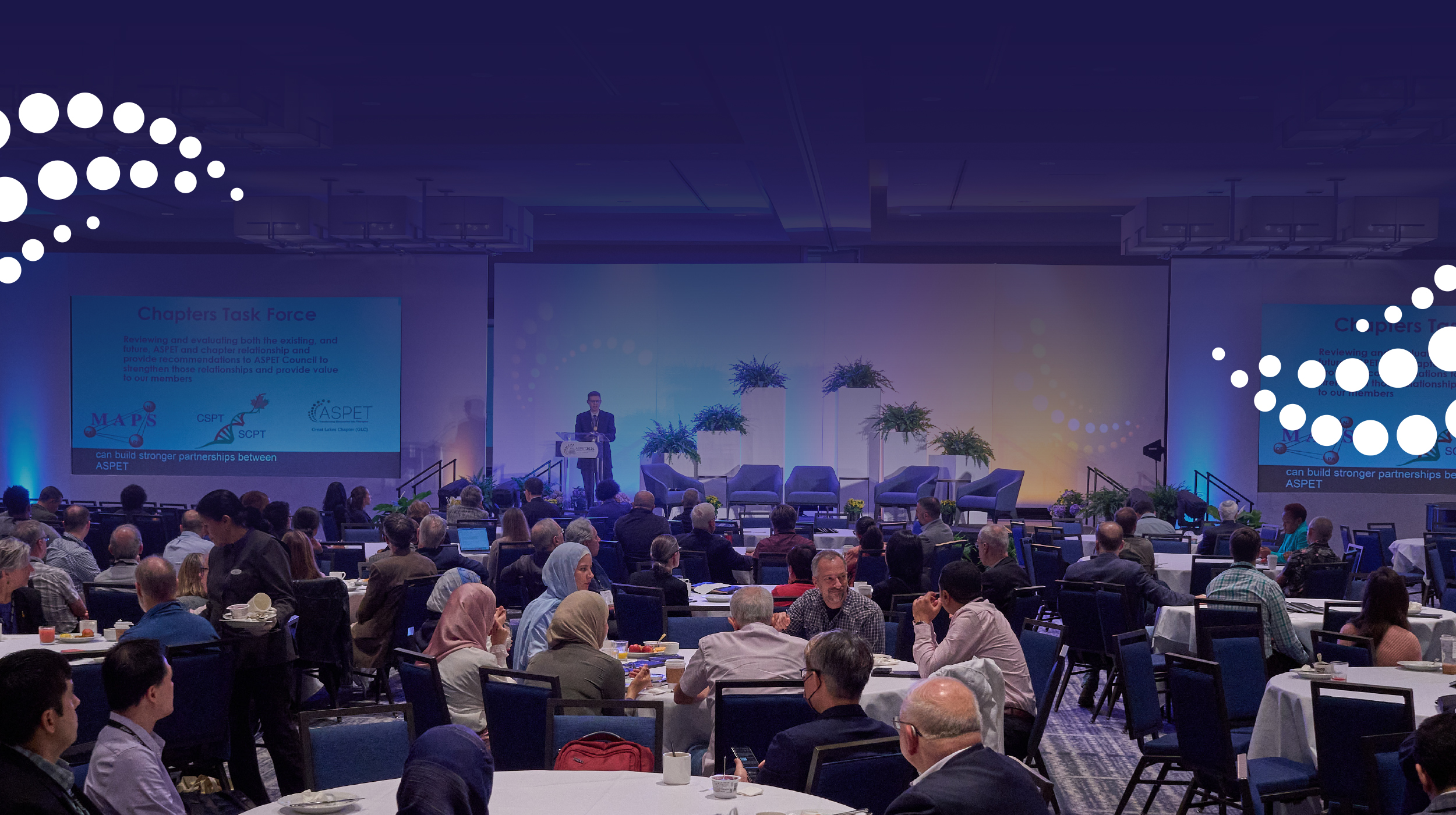 A conference room with ASPET members seated at circular tables during ASPET 2024 in Arlington, Virginia